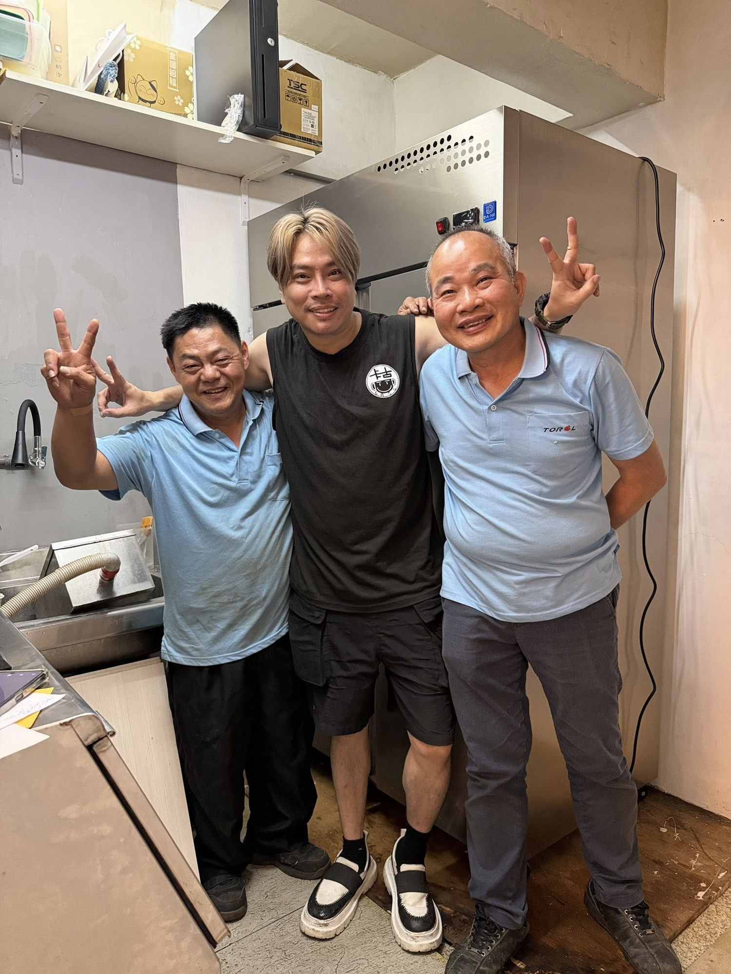 Kagu standing beside his new TOROL 1,100L inverter combo fridge